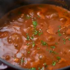 a pot filled with meat and vegetables on top of a stove