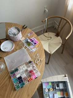 a wooden table topped with lots of crafting supplies