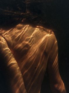 the back end of a woman's body in water