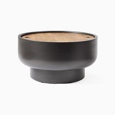 a black bowl with wood in the center on a white background, there is no image here to provide a caption for