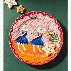 a plate with some decorations on it and a cookie next to it that says more ladies dancing