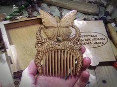 a person holding a wooden comb in their hand