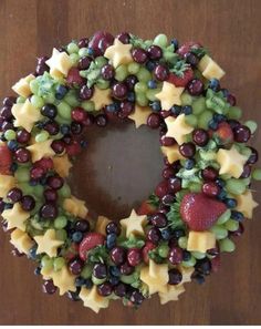 a wreath made out of grapes, strawberries and broccoli