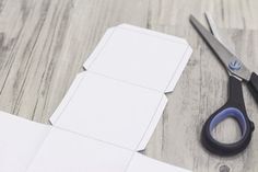 scissors and cut out paper sitting on top of a table