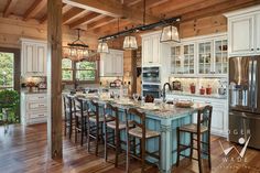 a large kitchen with an island in the middle and lots of counter space on each side