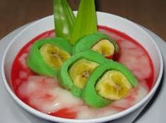 a bowl filled with fruit and vegetables on top of a table