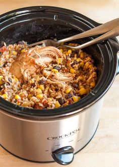 a slow cooker filled with rice and meat