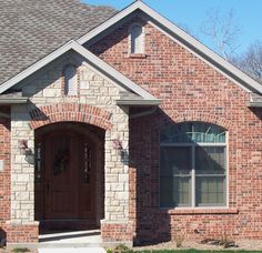 a brick house with a brown front door