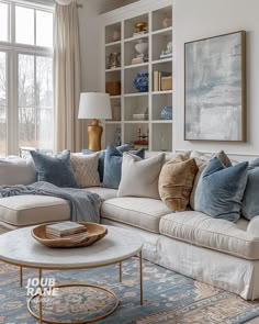 a living room filled with lots of furniture next to a large window covered in bookshelves