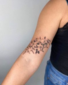 a woman with a flower tattoo on her arm