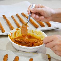 a person spooning some food out of a bowl