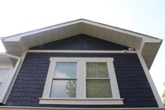 a blue house with white trim and windows