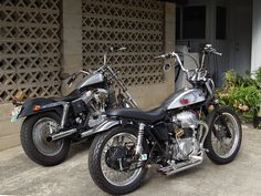 two motorcycles parked next to each other in front of a building