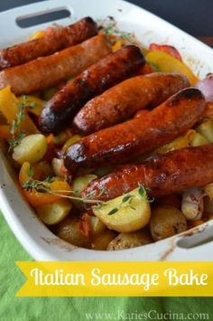 sausages and potatoes in a white casserole dish on a green tablecloth