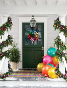 the front door is decorated for christmas with colorful balloons and garlands on the porch