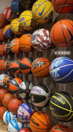 several basketballs are on display in a store