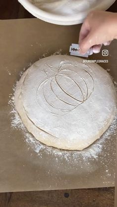 a person is kneading dough on a table