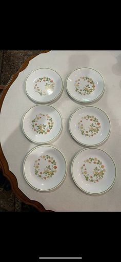 six plates sitting on top of a table next to each other in the shape of a circle