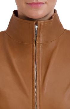 A soft lambskin leather jacket features a wing collar for contemporary style. 22" length Wing collar Long sleeves Front zip closure Front on-seam pockets Lambskin leather construction Lined Shell: 100% leather/lining: 100% polyester Professional leather clean Imported Model stats: 5'10" height, 32" bust, 25" waist, 36" hip. Model is wearing size S. Wing Collar, Collar Leather Jacket, Lambskin Leather Jacket, Leather Cleaning, Lambskin Leather, Cole Haan, Nordstrom Rack, Contemporary Style, Nordstrom