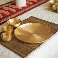 gold plates and bowls on a place mat