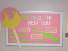 a bulletin board with pink and yellow paper on it that says into the new you