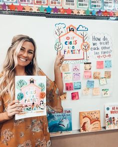 a woman standing in front of a bulletin board