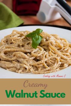 creamy walnut sauce on a white plate with green leafy garnish and text overlay