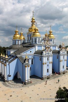 a blue and white church with gold domes