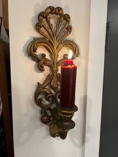 a red candle is lit on the wall