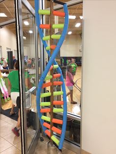 a colorful spiral shaped object in front of a glass door