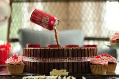 cupcakes with pink frosting being poured onto the top by a coca - cola can