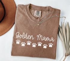 You will love this Comfort Colors golden mama shirt! This is the perfect trendy tee golden retriever moms can wear any time of year and makes a great gift for dog moms! PRODUCTION TIME: 1-3 business days  SHIPPING TIME: 2-5 business days  PRODUCT DESCRIPTION: These ultra soft pigment dyed shirts are one of our best sellers, 100% Cotton. 100% ring spun cotton Preshrunk, soft-washed, garment-dyed fabric Set-in sleeves Double-needle stitched sleeves and bottom hem Twill taped shoulder-to-shoulder 1" ribbed collar with double-needle topstitched neckline * For T-shirt Sizes Please refer to the Listing Image. CARE INSTRUCTION: To keep your garment looking its best, please follow these simple care instructions: Turn the garment inside out before washing. Machine wash cold with similar colors, use Doxie Dog, Golden Retriever Mom, Dog Mom Tee, Dachshund Shirt, Bulldog Mom, Bulldog Shirt, Mama T Shirt, Dog Christmas Gifts, Fabric Set