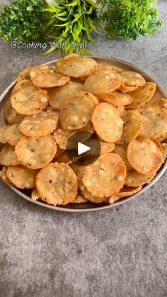 a platter filled with crackers on top of a table next to parsley