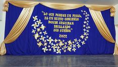 the stage is decorated with blue and gold drapes