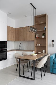 a kitchen with a table, chairs and an oven in the backround area