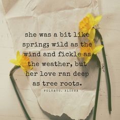 two yellow daffodils sitting on top of a piece of paper with a quote about spring