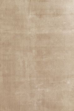 a beige area rug with no pattern on it