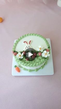 a cake decorated with an easter bunny and flowers