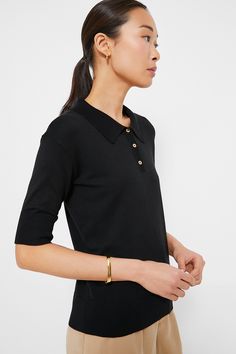 You'll wear this Black Milo Sweater Polo for seasons to come. Crafted from a buttery soft fabric, this classic style staple features fitted sleeves that can be slightly pulled up for a little puffed look. The straight shape and ribbed hem makes it perfect for layering, tucking in, and cosying up in. We are wearing it with denim, trousers, mini skirts (must we go on?) from work to play with ease and style. Spread collar Fitted sleeves Front three button placket Ribbed collar, cuff and hem Straigh Sleek Tops With Button Cuffs For Fall, Formal Black Top With Ribbed Collar, Classic Formal Tops With Ribbed Cuffs, Fitted Tops With Button Cuffs For Everyday, Fitted Top With Button Cuffs For Everyday, Elegant Top With Ribbed Cuffs And Relaxed Fit, Elegant Relaxed Fit Top With Ribbed Cuffs, Summer Style Guide, Sweater Polo