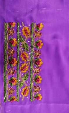 an embroidered purple cloth with flowers on it