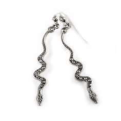 These slithering snake earrings are the replicas of Elvira's originals. They will peek out around your face, adding an edgy hint to your look. Size: 2.75" long. Delicately designed and handcrafted, set with premium crystal and finished in your choice of bronze or silver. "I've always been drawn to snakes. Perhaps it's because they are beautiful and misunderstood, or maybe it's the thrill of holding a creature that most people fear. Either way, they are fascinating and have such unique personalit Elvira Jewelry, Slithering Snake, Locket Bracelet, Snake Earrings, Bridal Bracelet, Jewelry Repair, Jewelry Companies, Girls Jewelry, Bridal Necklace