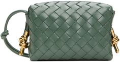 Intrecciato-woven polished calfskin crossbody bag in green. · Knotted accents at adjustable crossbody strap · Knotted hardware at sides · Zip closure · Bonded buffed calfskin lining · Gold-tone hardware · H4.5 x W6.5 x D2.5 Supplier color: Aloe muse brass Green Intrecciato Weave Formal Shoulder Bag, Green Formal Shoulder Bag With Intrecciato Weave, Formal Green Shoulder Bag With Intrecciato Weave, Formal Green Woven Leather Bag, Green Woven Leather Formal Bag, Bottega Veneta Green, Bottega Veneta Bags, Mini Camera, Mini Crossbody Bag