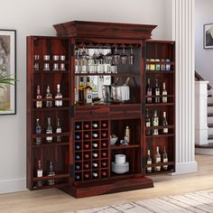 a large wooden cabinet filled with bottles and glasses