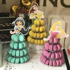 there are three princess macaroons on the table