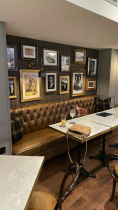 a restaurant with leather booths and pictures on the wall