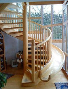 there are two pictures of a spiral staircase in the same room, and one is empty