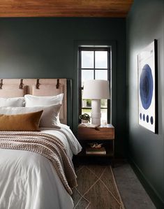 a bedroom with green walls and white bedding