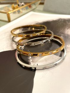 These chic bangles are crafted with fine details, featuring sparkling zircon and luxurious gold plating. Add a touch of elegance to any outfit and stand out from the crowd. Upgrade your style with Emma Bracelets today! Gold Bangle With Cubic Zirconia Sparkling Stones, Elegant Stackable Crystal Bangle Bracelet, Glamorous Gold Bangle Bracelets, Glamorous Gold Bangle Bracelet, Gold-plated Bangle Bracelets With Diamond Accents, Elegant Stackable Gold Bracelet With Cz, Elegant Stackable Gold Bracelet With Cubic Zirconia, Luxury Gold-plated Bangle For Party, Elegant Gold Plated Silver Bangle