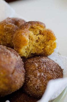 a bunch of doughnuts sitting on top of a white plate