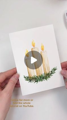 someone holding up a card with candles on it